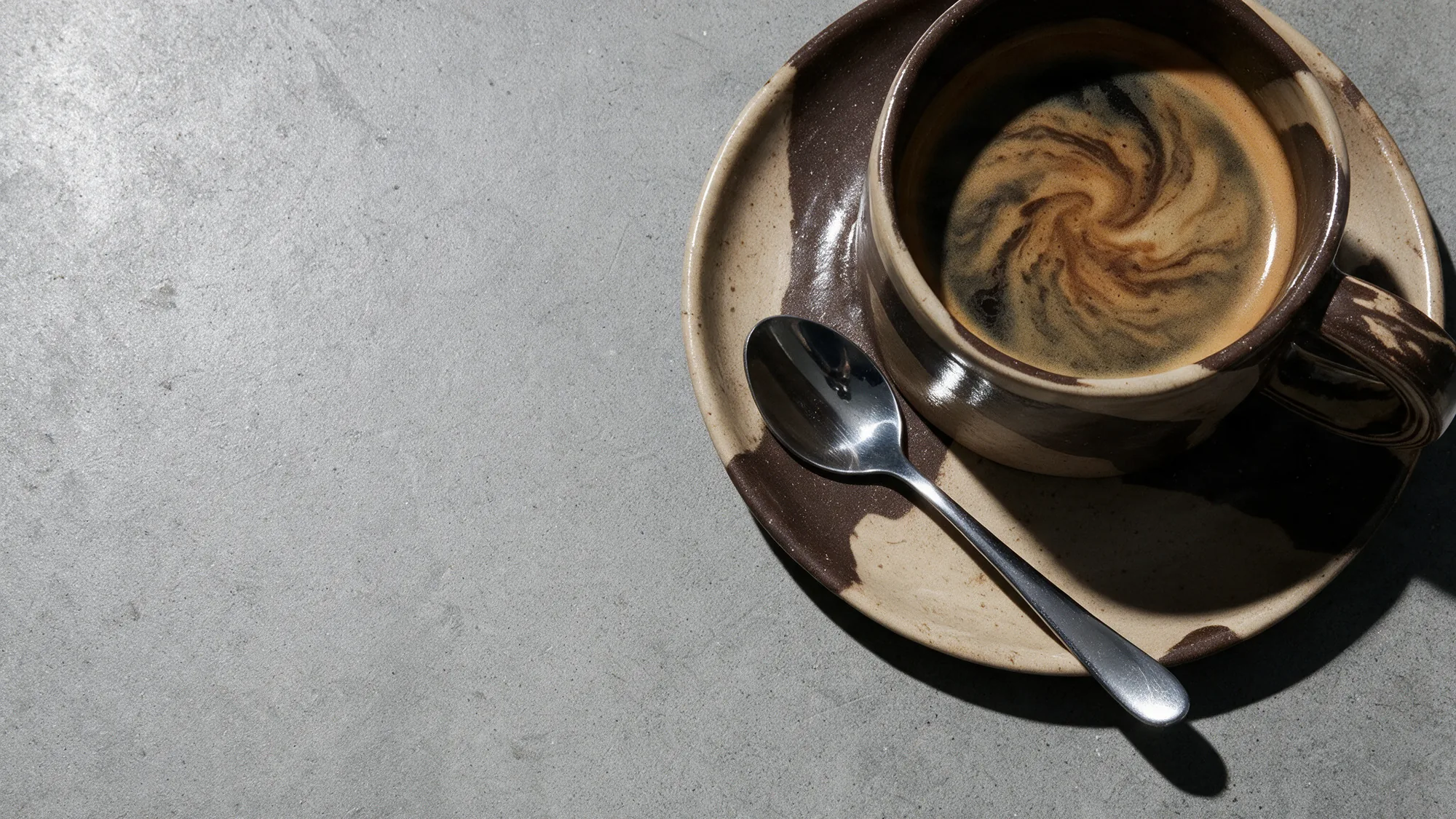 Espresso in handgetöpferter Tasse auf Beton